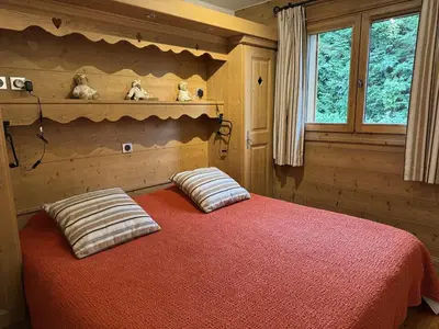 a bedroom with a bed with two pillows on it at Appartement de standing 6 pers avec piscine et parking - FR-1-836-3 in Arâches-la-Frasse