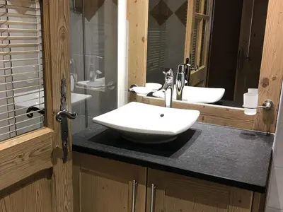 a bathroom with two sinks and two mirrors at Appartement de standing 6 pers avec piscine et parking - FR-1-836-3 in Arâches-la-Frasse