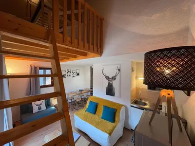 a room with a loft bed and a living room at Studio avec mezzanine, balcon et parking privé - Animaux acceptés - FR-1-836-9 in Arâches-la-Frasse