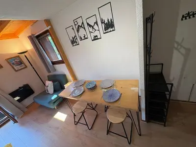 a dining room with a table and chairs in a room at Studio avec mezzanine, balcon et parking privé - Animaux acceptés - FR-1-836-9 in Arâches-la-Frasse