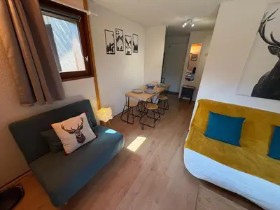a room with a bed and a couch and a table at Studio avec mezzanine, balcon et parking privé - Animaux acceptés - FR-1-836-9 in Arâches-la-Frasse