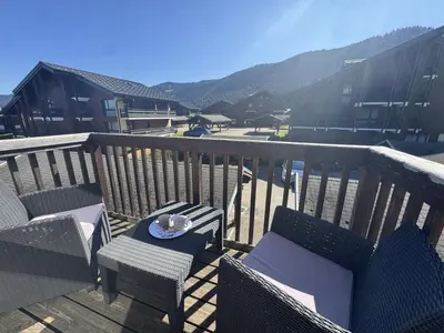 a balcony with chairs and a plate of food at Studio avec mezzanine, balcon et parking privé - Animaux acceptés - FR-1-836-9 in Arâches-la-Frasse
