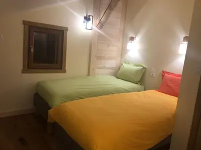 an empty bed in a room with a mattress at Ferme rénovée centre-ville 3 chambres, 6/8 pers, Parking - FR-1-836-2 in Arâches-la-Frasse