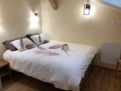 a bedroom with a wooden wall with a table and lights at Ferme rénovée centre-ville 3 chambres, 6/8 pers, Parking - FR-1-836-2 in Arâches-la-Frasse
