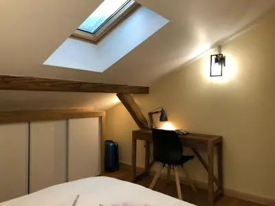 a bedroom with a bed with white sheets and pink feathers at Ferme rénovée centre-ville 3 chambres, 6/8 pers, Parking - FR-1-836-2 in Arâches-la-Frasse