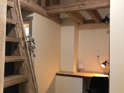 a room with a wooden door and a lamp at Ferme rénovée centre-ville 3 chambres, 6/8 pers, Parking - FR-1-836-2 in Arâches-la-Frasse