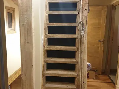 a wooden ladder in a room with a door at Ferme rénovée centre-ville 3 chambres, 6/8 pers, Parking - FR-1-836-2 in Arâches-la-Frasse