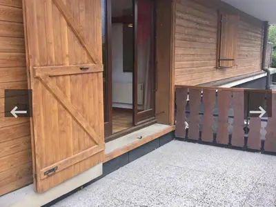 an open door of a house with wooden doors at Appartement central 1 chambre, 4 pers, WIFI, garage - FR-1-836-12 in Arâches-la-Frasse