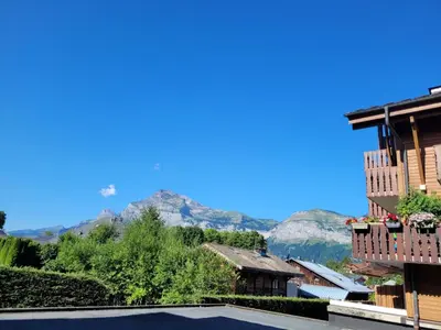 a tennis court with mountains in the background at Appartement central 1 chambre, 4 pers, WIFI, garage - FR-1-836-12 in Arâches-la-Frasse