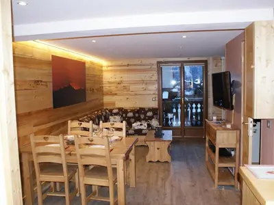 a dining room with wooden walls and a table and chairs at Appartement rénové 50 m², 2 chambres, centre, WIFI - FR-1-836-6 in Arâches-la-Frasse