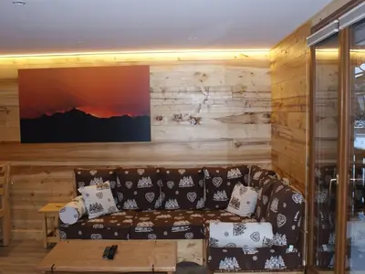 a living room with a couch and a flat screen tv at Appartement rénové 50 m², 2 chambres, centre, WIFI - FR-1-836-6 in Arâches-la-Frasse