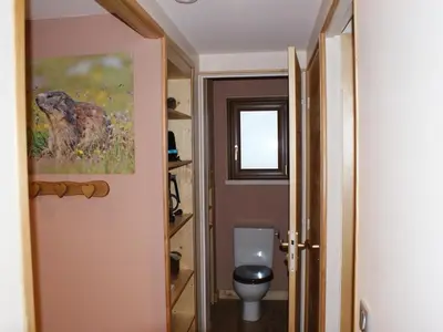 a bathroom with a toilet and a picture of a dog at Appartement rénové 50 m², 2 chambres, centre, WIFI - FR-1-836-6 in Arâches-la-Frasse