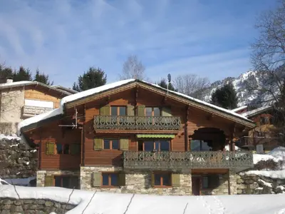 a log cabin in the snow with a balcony at Appartement 2 chambres pour 5 pers avec billard et parking - FR-1-836-11 in Arâches-la-Frasse