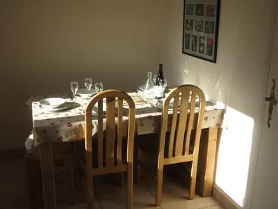 a table with two chairs and a table with wine glasses at Appartement 2 chambres pour 5 pers avec billard et parking - FR-1-836-11 in Arâches-la-Frasse