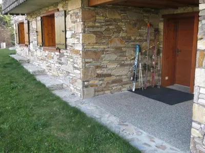 a building with a stone wall with a door at Appartement 2 chambres pour 5 pers avec billard et parking - FR-1-836-11 in Arâches-la-Frasse