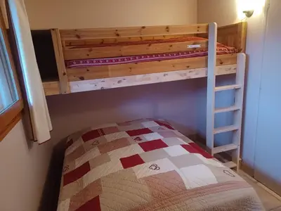 a bunk bed in a room with a bed sidx sidx sidx at Appartement 2 chambres pour 5 pers avec billard et parking - FR-1-836-11 in Arâches-la-Frasse