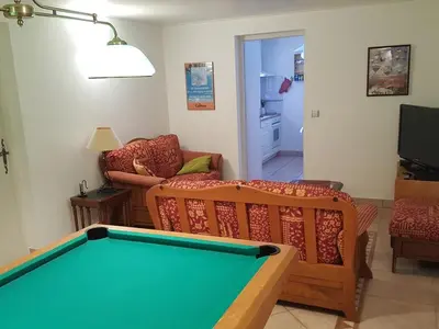 a living room with a pool table at Appartement 2 chambres pour 5 pers avec billard et parking - FR-1-836-11 in Arâches-la-Frasse