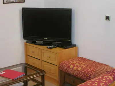a living room with a tv on a wooden dresser at Appartement 2 chambres pour 5 pers avec billard et parking - FR-1-836-11 in Arâches-la-Frasse