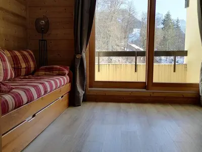 a room with a couch and a large window at Studio 26 m² - 4 pers - Les Carroz d'Arâches - FR-1-836-10 in Arâches-la-Frasse
