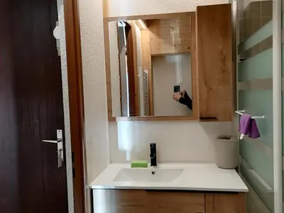 a person taking a picture of a bathroom sink at Studio 26 m² - 4 pers - Les Carroz d'Arâches - FR-1-836-10 in Arâches-la-Frasse