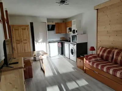 a living room with a couch and a kitchen at Studio 26 m² - 4 pers - Les Carroz d'Arâches - FR-1-836-10 in Arâches-la-Frasse