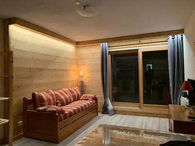 a living room with a couch and a window at Studio 26 m² - 4 pers - Les Carroz d'Arâches - FR-1-836-10 in Arâches-la-Frasse