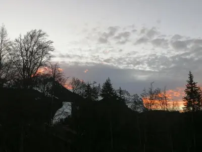 a sunset with trees and clouds in the sky at Studio 26 m² - 4 pers - Les Carroz d'Arâches - FR-1-836-10 in Arâches-la-Frasse