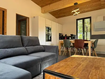 a living room with a couch and a table at Comfortable house - 4 people - quiet in Chamonix-Mont-Blanc