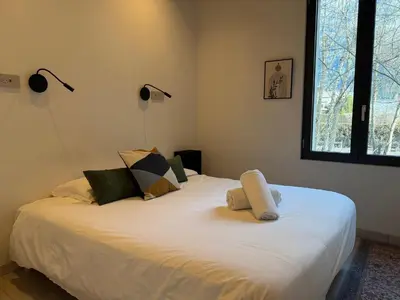 a bedroom with a large white bed with two pillows at Comfortable house - 4 people - quiet in Chamonix-Mont-Blanc
