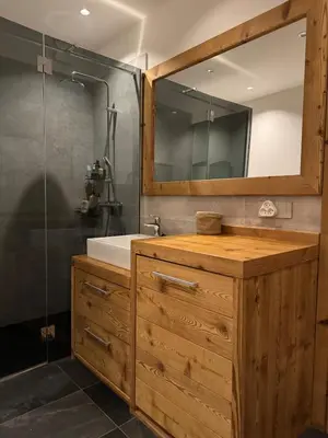 a bathroom with a sink and a shower with a mirror at Comfortable house - 4 people - quiet in Chamonix-Mont-Blanc