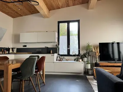 a kitchen with a table and a tv in a room at Comfortable house - 4 people - quiet in Chamonix-Mont-Blanc
