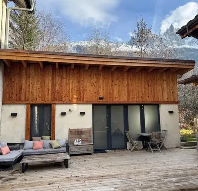 a house with a patio with a table and chairs at Comfortable house - 4 people - quiet in Chamonix-Mont-Blanc