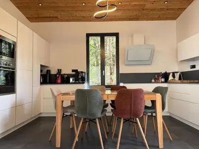 a kitchen with a wooden table and chairs at Comfortable house - 4 people - quiet in Chamonix-Mont-Blanc