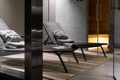 a black table and a chair in a room at Chalet Crystal in Megève