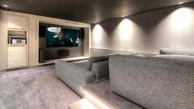 a living room with a couch and a tv at Chalet Crystal in Megève