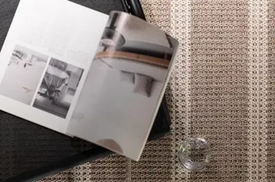 a book sitting on top of a table with a glass at Chalet Crystal in Megève