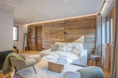 a living room with a white couch and a table at Duplex Veyra - Welkeys in Megève