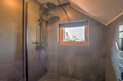 a bathroom with a shower with a mirror at Duplex Veyra - Welkeys in Megève