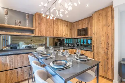 a dining room with a table and chairs at Duplex Veyra - Welkeys in Megève