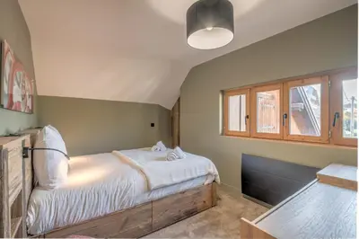 a bedroom with a bed and a window at Duplex Veyra - Welkeys in Megève
