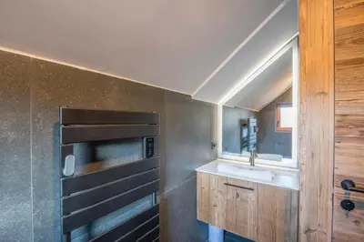 a kitchen with a sink and a microwave at Duplex Veyra - Welkeys in Megève