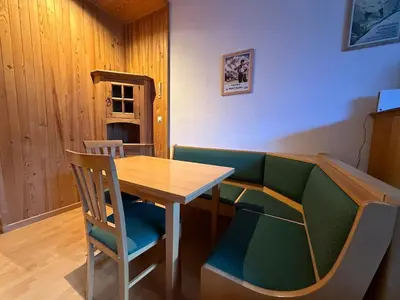 a table and chairs in a room with a table at Charmant studio Chamonix in Chamonix-Mont-Blanc