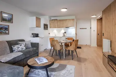 a living room with a couch and a table at Alpine Bliss - Sources, Ski in Saint-Gervais-les-Bains