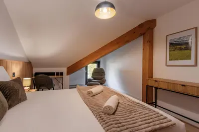 a bedroom with a bed and a fireplace in a room at Alpine Bliss - Sources, Ski in Saint-Gervais-les-Bains