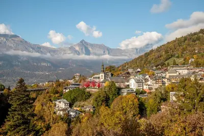 a town on a hill with mountains in the background at Alpine Bliss - Sources, Ski in Saint-Gervais-les-Bains