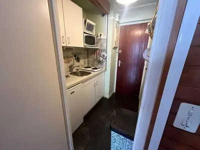 a small kitchen with white cabinets and a sink at Appartement à Arâches-la-Frasse pour 4 personnes - FR-1-572-334 in Arâches-la-Frasse