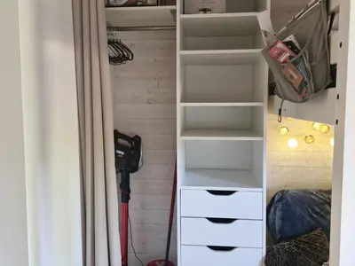 a closet with white drawers and shelves in a room at Studio rénové pour 4 au pied de la piste de luge - FR-1-836-13 in Arâches-la-Frasse