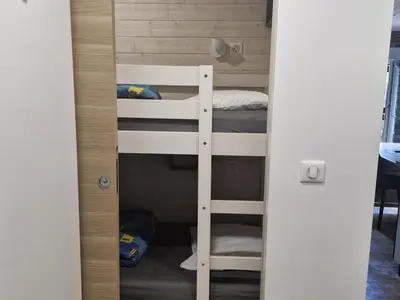 a room with bunk beds in a small room at Studio rénové pour 4 au pied de la piste de luge - FR-1-836-13 in Arâches-la-Frasse