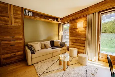 a living room with a couch and a table at Le Majestic - Proche pistes et centre ville in Megève