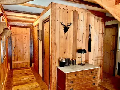 a room with a wooden wall with a desk in it at Cozy apartment chalet atmosphere in Megève